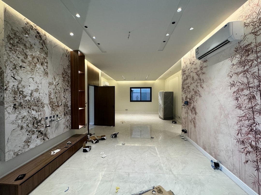 Modern room under renovation with marble and bamboo walls.